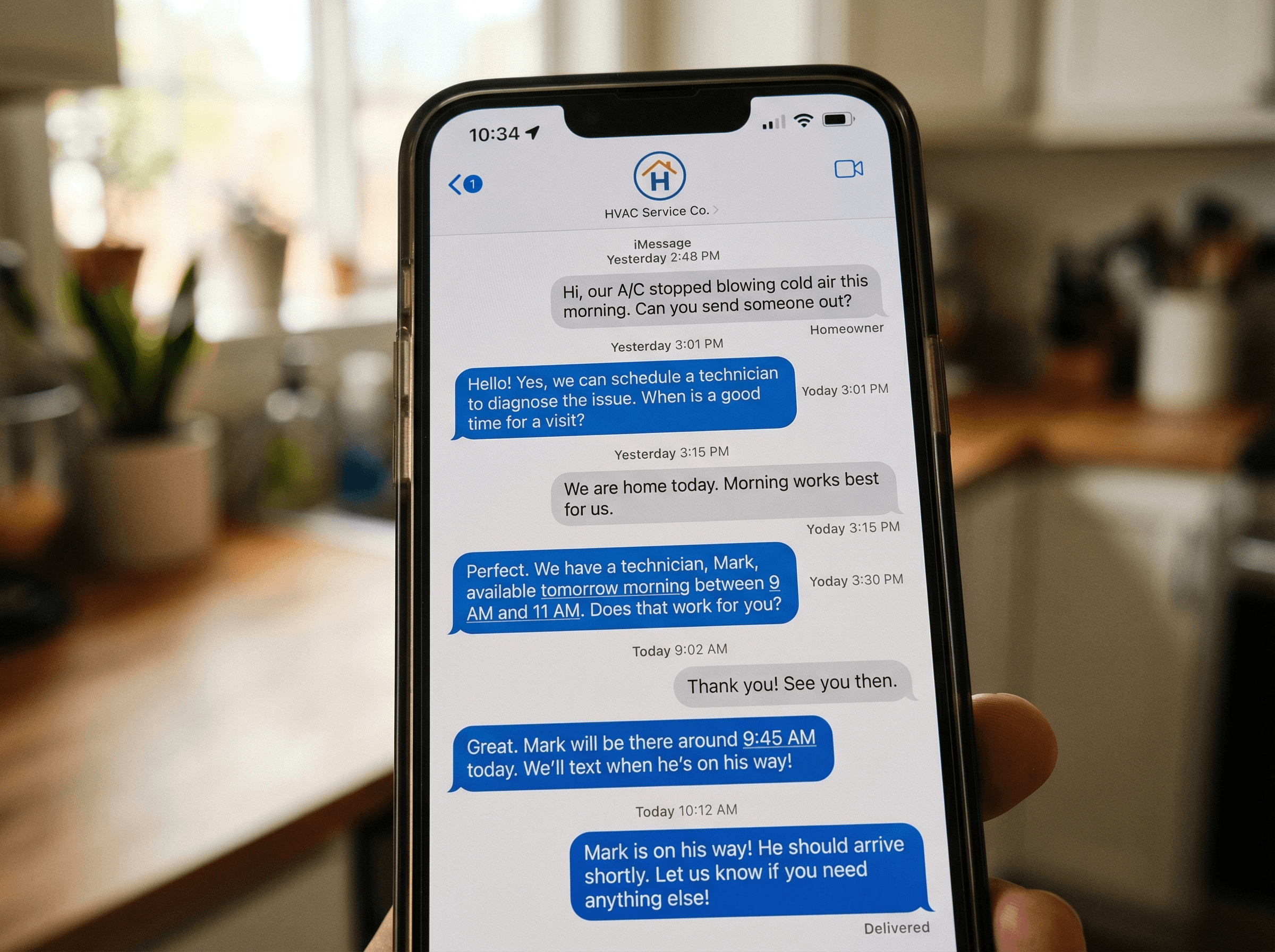 Smartphone showing text message conversation with HVAC service company